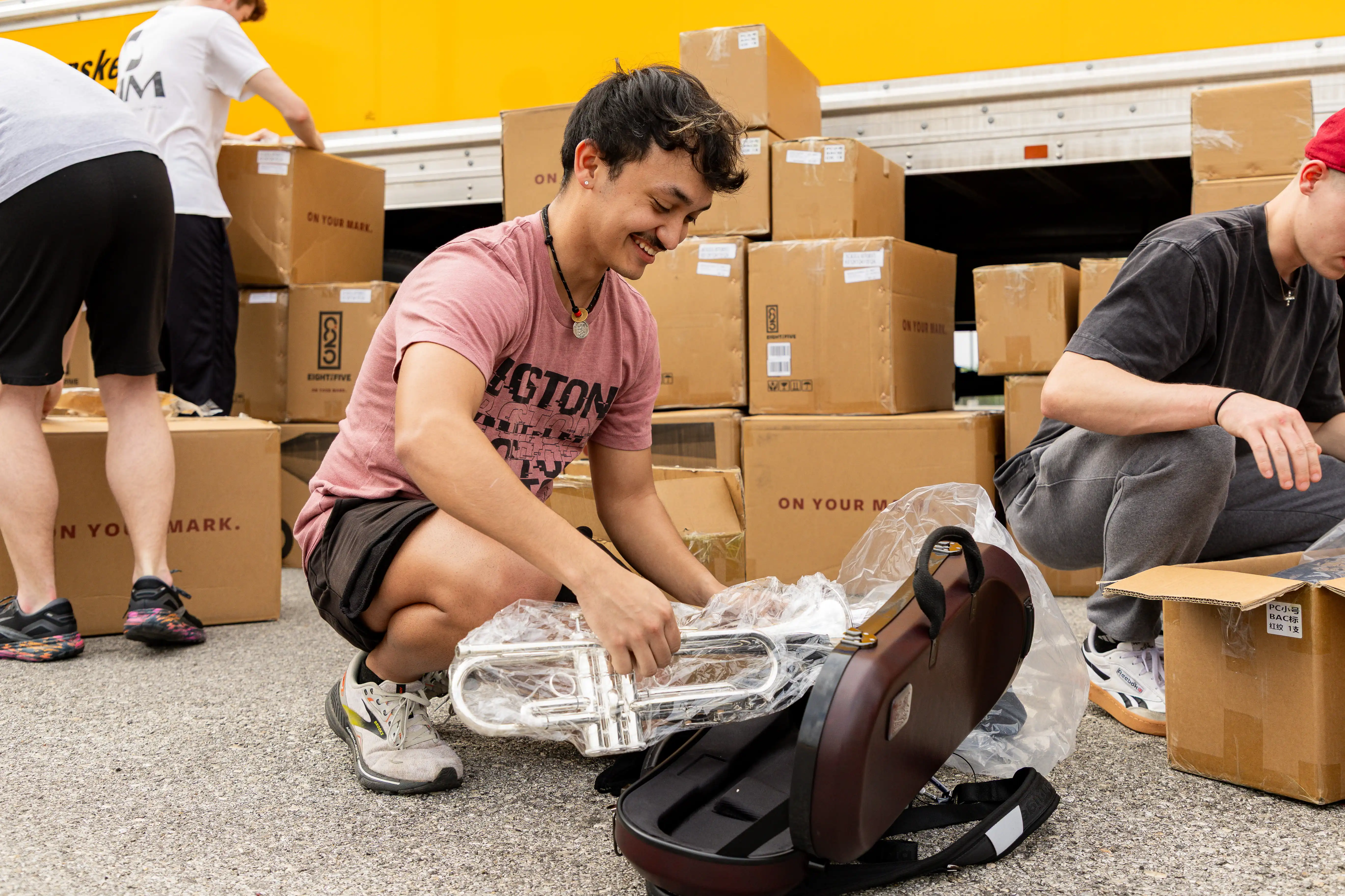 Musicians unpacking newly delivered instruments.